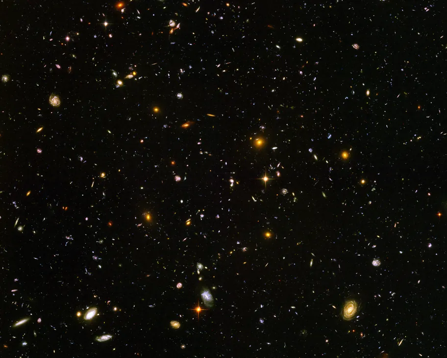 Deep field view showing thousands of galaxies in a tiny patch of sky