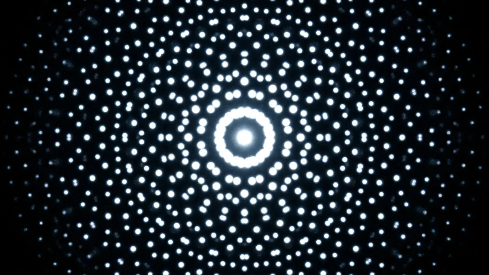 Electron diffraction pattern of an icosahedral quasicrystal - the five-fold symmetry appears as a ten-fold ring of sharp bright dots (diffraction adds an inversion center), a pattern impossible in any periodic crystal